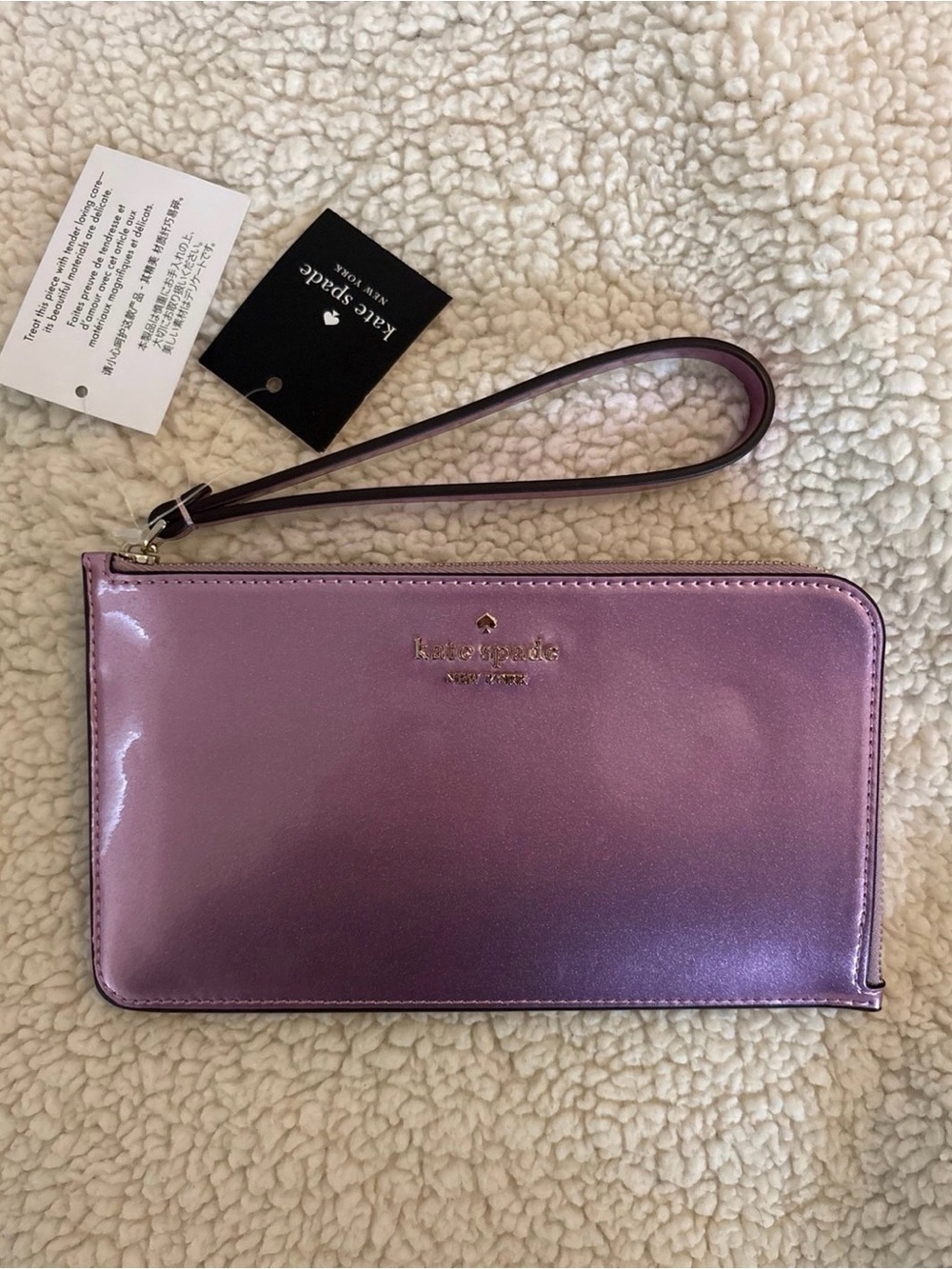 kate spade iridescent pink wristlet with gold logo